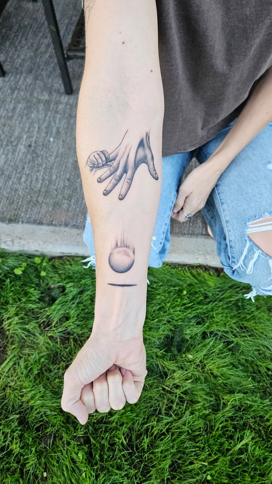 Victoria's tattoo — a hand releasing a ball, already falling — a permanent testimony to the principle of Dropping the Ball